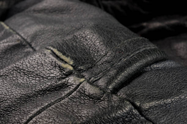 istock Old vintage genuine soft black leather texture background, top layer with pores and scratches, macro, close-up 1153318282