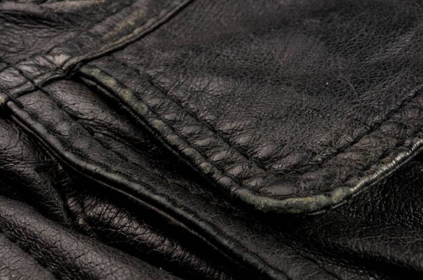 istock Old vintage genuine soft black leather texture background, top layer with pores and scratches, macro, close-up 1153318372
