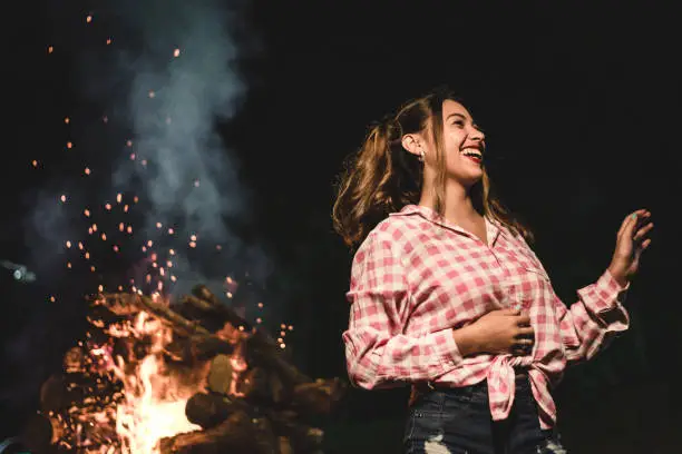 Photo of Woman and the bonfire of the traditional Junina Fest in Brazil