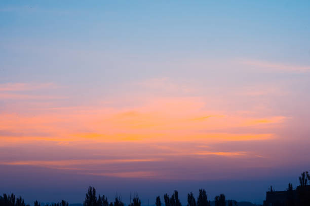 Landscape with dramatic light - beautiful golden sunset with saturated sky and clouds, peaceful nature serene background.