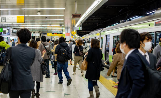 Many passengers leave the train at Tokyo station. stock photo
