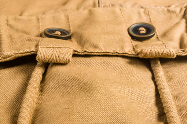 istock clothing items washed cotton fabric texture with seams, clasps, buttons and rivets 1153320537