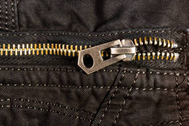 istock clothing items stonewashed cotton fabric texture with seams, clasps, buttons and rivets, macro 1153321555