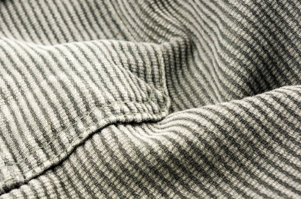 istock clothing items stonewashed cotton fabric texture with seams, clasps, buttons and rivets, macro 1153321657