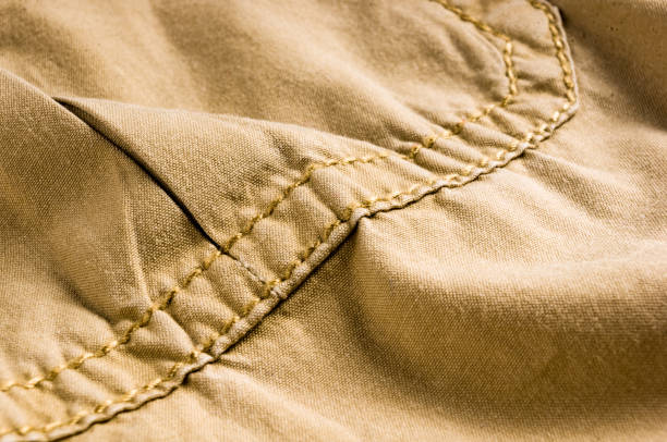 istock clothing items stonewashed cotton fabric texture with seams, clasps, buttons and rivets, macro 1153321694