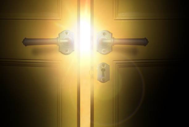 istock Open yellow door with bright sunlight 1153324490