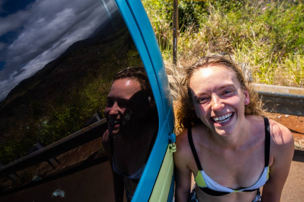 istock Smiling Woman In Bathing Suit With Reflection In Car Window 1153324501