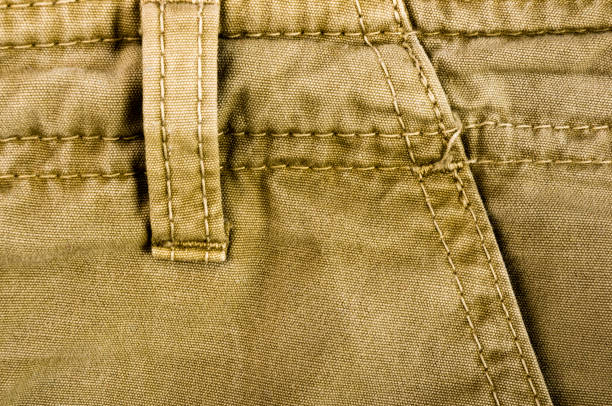 istock clothing items stonewashed cotton fabric texture with seams, clasps, buttons and rivets, macro 1153327655
