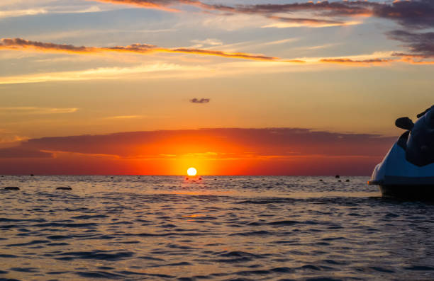 istock silhouette of a jet ski in the sun 1153327731