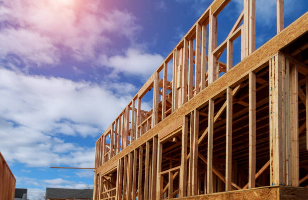istock Looking up new construction beams under a clear blue sky with sunlight 1153331505