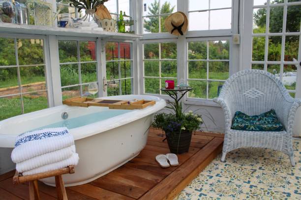 istock Beautiful greenhouse with large soaking tub ready for a bath 1153333823