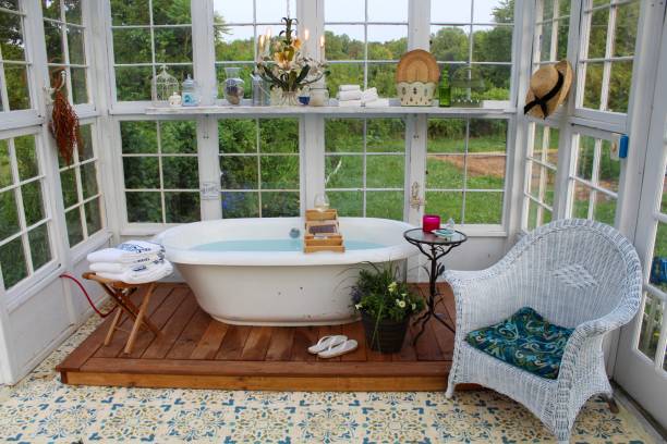 istock Beautiful greenhouse with large soaking tub ready for a bath 1153333896
