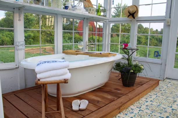 istock Beautiful greenhouse with large soaking tub ready for a bath 1153333951