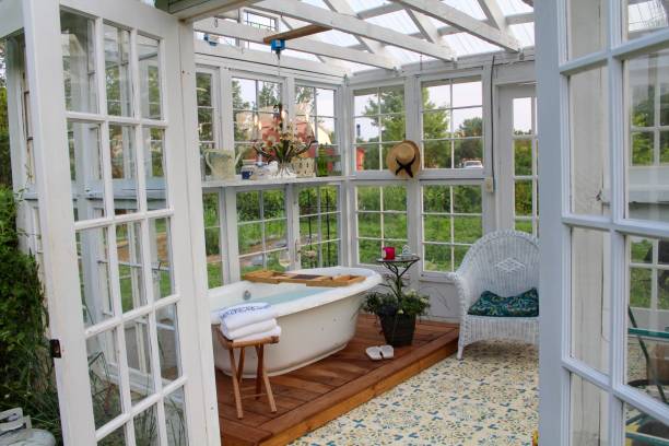 istock Beautiful greenhouse with large soaking tub ready for a bath 1153334027