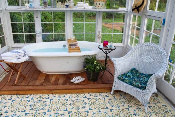 istock Beautiful greenhouse with large soaking tub ready for a bath 1153334073