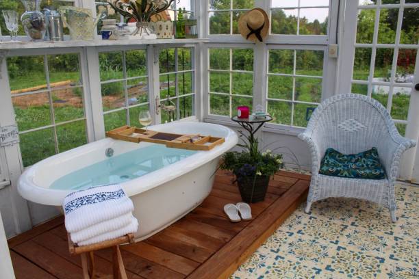 istock Beautiful greenhouse with large soaking tub ready for a bath 1153334098