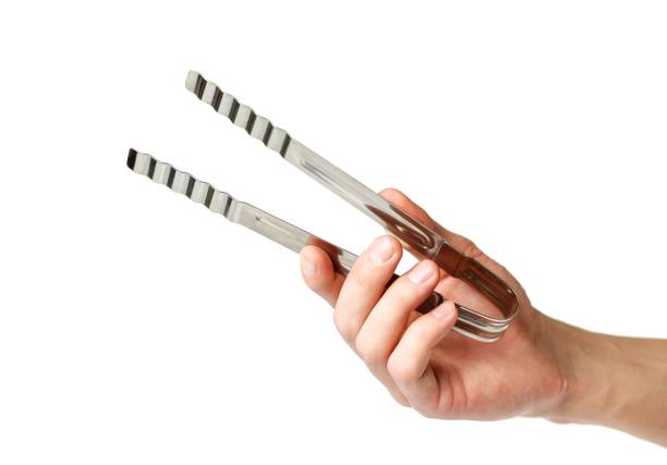 istock The hand holding the clamp. Close up. Isolated on white background 1153334263