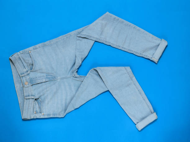 istock Light blue jeans on a bright blue background. Flat lay. 1153335276