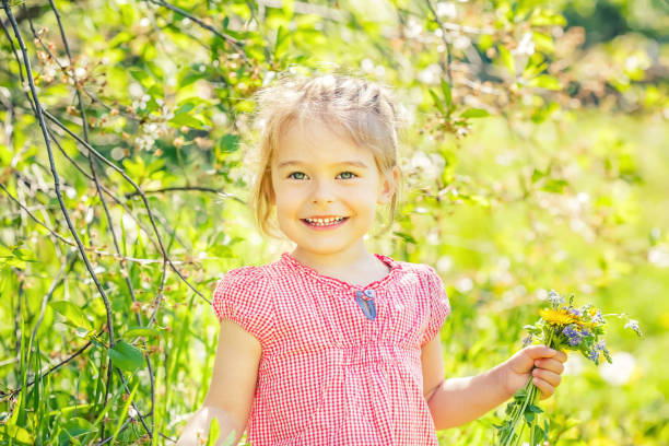 istock Happy little girl in spring sunny park 1153335896