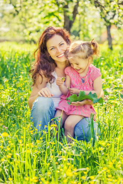 istock Mother and daughter in sunny park 1153335911