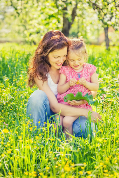 istock Mother and daughter in sunny park 1153335922