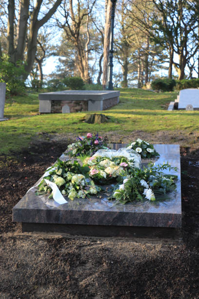 istock Sympathy flowers on a grave 1153337483