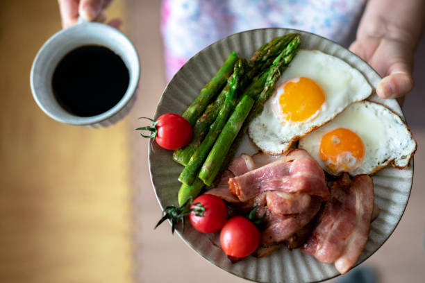 istock homemade healthy breakfast:coffee, fried egg and bacon, vegetables 1153338093
