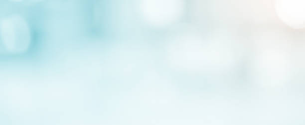 istock abstract blur soft focus blue color modern workplace background with shine light for design concept 1153338154