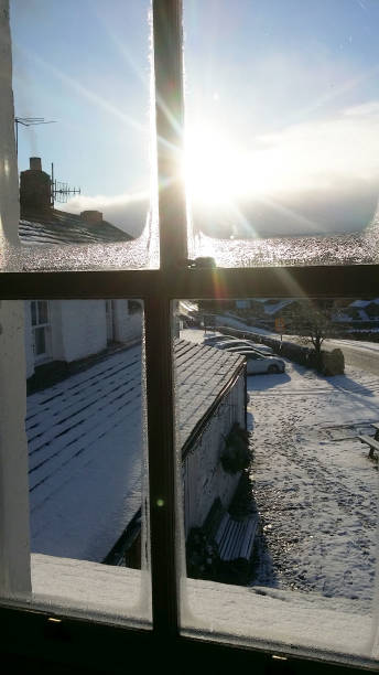 istock Viewing though the window see white snow, sunshine, blue sky with white clouds beautiful morning 1153343265