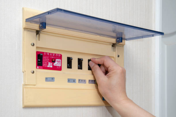 istock The electrician on hand opens circuit breaker board. Electrical Safety Concept. 1153347820