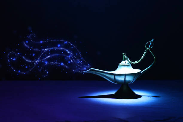 istock Image of magical mysterious aladdin lamp with glitter smoke. Dark background and dramatic light 1153349389