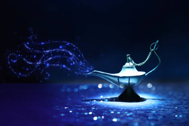 istock Image of magical mysterious aladdin lamp with glitter smoke. Dark background and dramatic light 1153349499