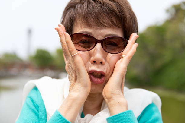 istock Senior woman making funny face 1153353268