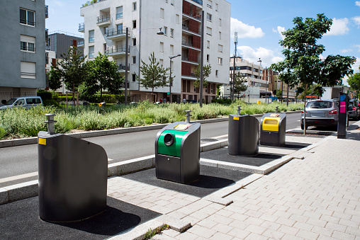 Waste bins in a city centre of Massy in France in front of a building