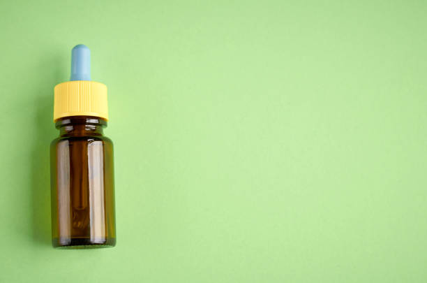 istock Nasal drops bottle composition, glass bottle green background 1153358497