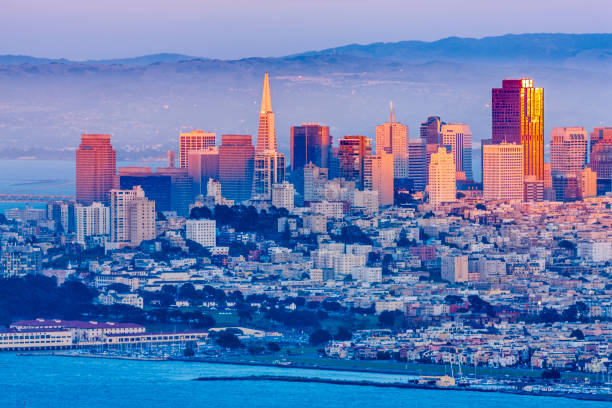 San Francisco Bay area in California San Francisco city skyline seen from the Marin Headlands in California at sunset transamerica pyramid san francisco stock pictures, royalty-free photos & images