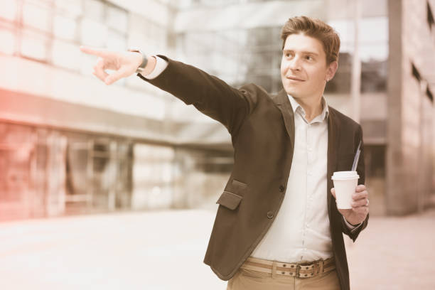 istock Smiling businessman with cup of coffee 1153361097