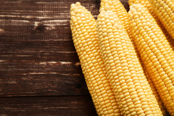 istock Ripe corn on brown wooden table 1153366875