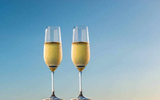 istock Two glasses of sparkling wine isolated on blue background. 1153367286