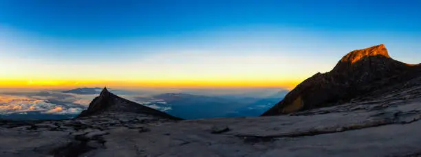 Panorama of St.John peak and South peak on Kinabalu national park with sunrise and triangle shadow behind.