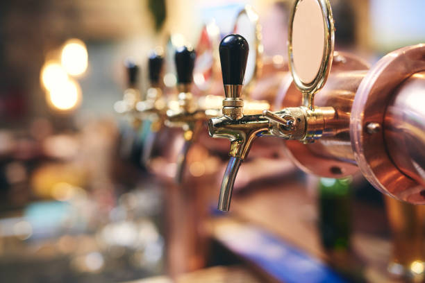 Shot of beer tap in the pub Shot of beer tap in the pub microbrewery stock pictures, royalty-free photos & images