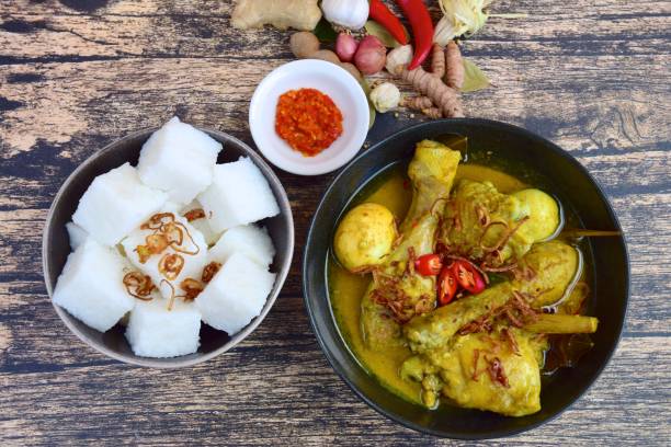 istock Opor ayam, chicken cooked in coconut milk added with boiled eggs. Originated from Central Java, Indonesia, served with Lontong and Sambal. Popular dish for lebaran or Eid al-Fitr 1153369794