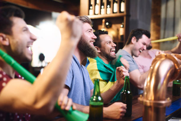 istock Happy men while watching american football 1153369805