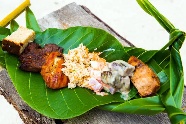 Fried meat with rice on a banana leaf, Bora Bora, French Polynesia. Close-up.