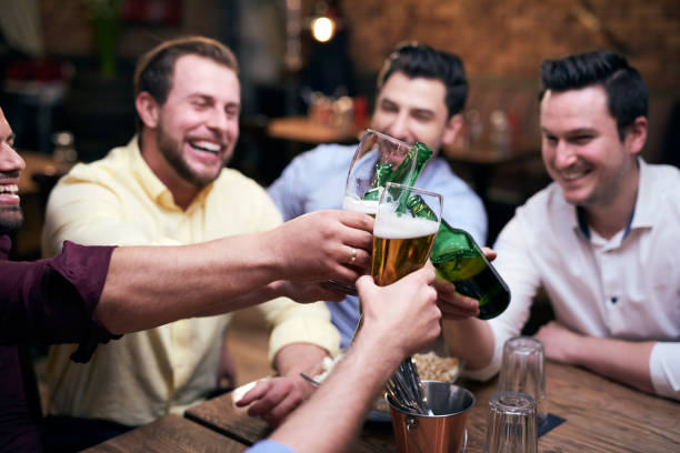 istock Group of men making a cheers at the bar 1153370127