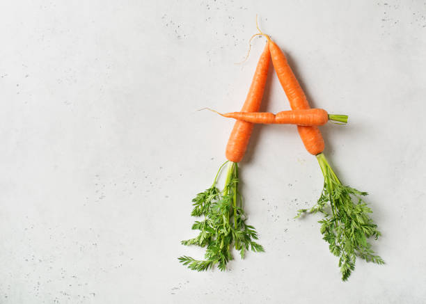 istock Letter from carrots, vitamin concept on white background 1153371010