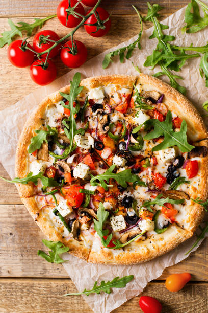 istock Vegetable italian pizza with tomatos on wodeen background 1153371013