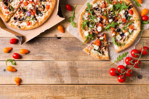 istock Vegetable italian pizza with tomatos on wodeen background 1153371181