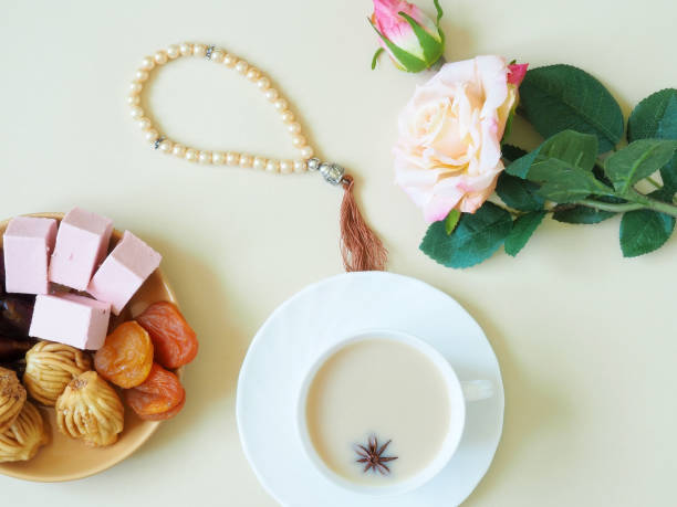 istock Sweets, marshmallow on a plate, tea on a beige background. Flower. 1153371543