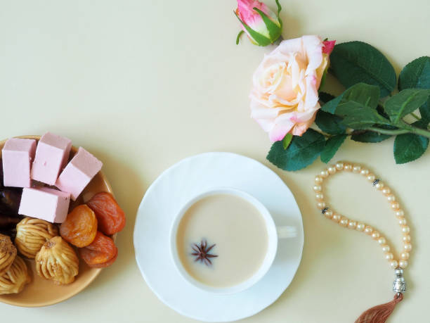 istock Sweets, marshmallow on a plate, tea on a beige background. Flower. 1153371561